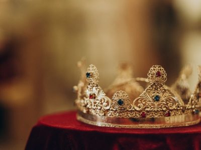 golden-crown-with-gemstones-on-red-napkin-on-altar-2021-08-29-07-16-50-utc